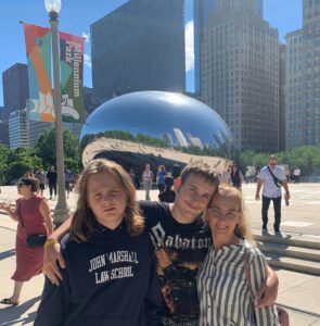 Maria and her two children in front of the Bean in Chicago