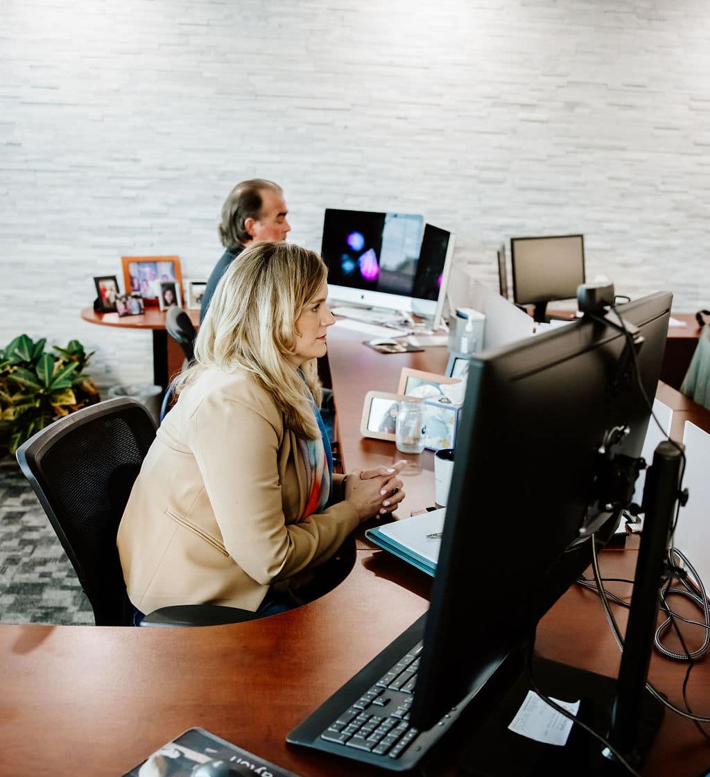 team sitting at computers listening to ai interpreting